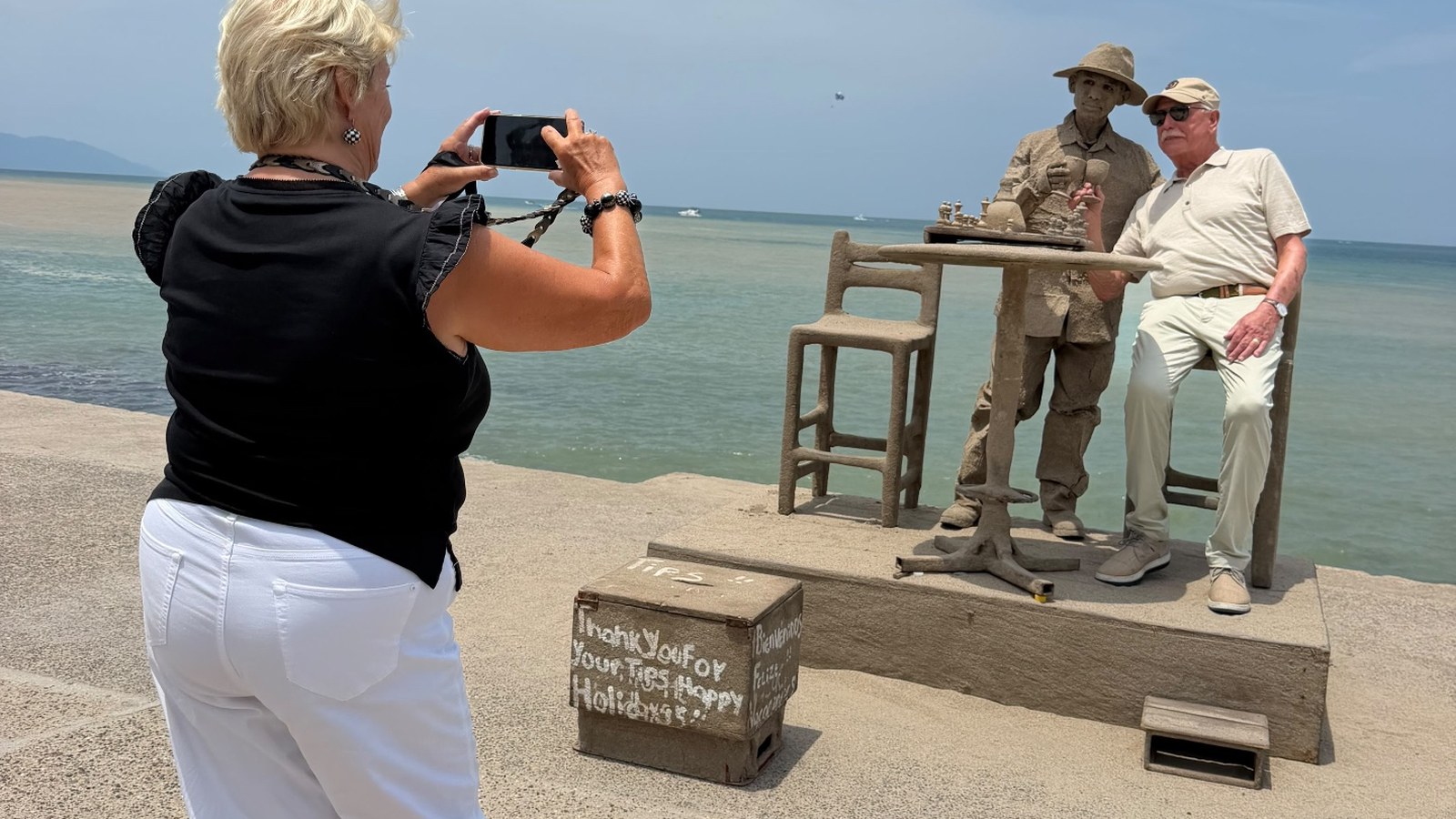 Guest photographing the famous sand sculptor on the Puerto Vallarta Malecón