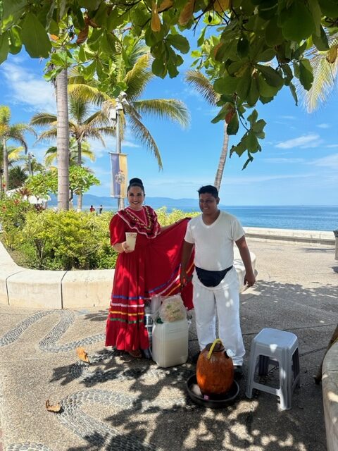 A traditional performer and coconut vendor beside the Puerto Vallarta waterfront